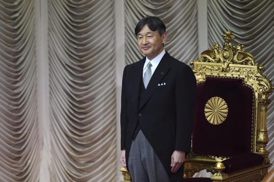 Japan's Emperor Naruhito stands as he opens formally an extraordinary session at the upper house of parliament in Tokyo Thursday, Aug. 1, 2019. Naruhito delivered his first opening speech since ascending to the Chrysanthemum Throne on May 1. (AP Photo/Eugene Hoshiko)