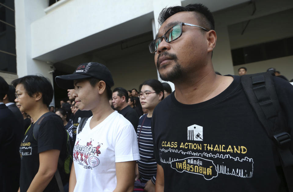 Plaintiffs of Ford cars with bad transmissions gather outside a civil court before a verdict in a class-action lawsuit in Bangkok, Thailand, Friday, Sept. 21, 2018. The Thai court has ordered Ford Motor Co. to pay 291 customers a total of around $720,000 in compensation for selling cars equipped with faulty transmissions. (AP Photo/Sakchai Lalit)