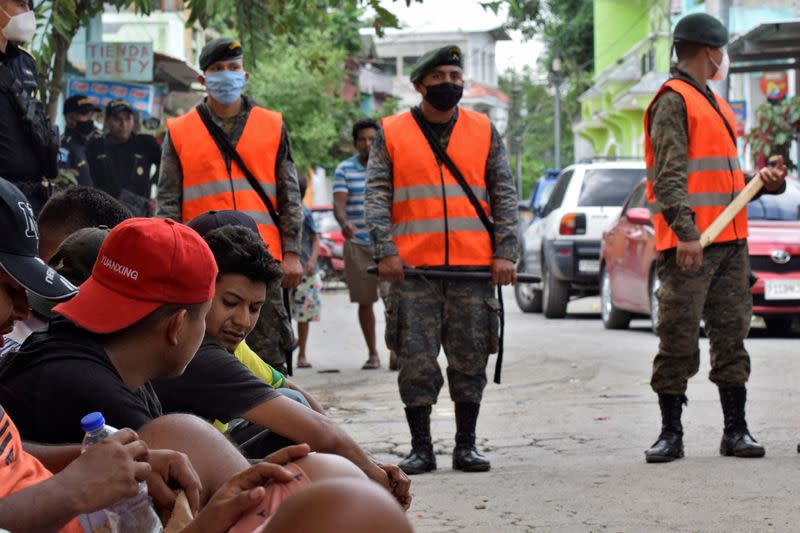 Guatemalan soldiers patrol to prevent a group of Honduran migrants who are trying to reach the U.S, from moving towards the Guatemala and Mexico border, as they sit outside the migrant shelter , in Tecun Uman