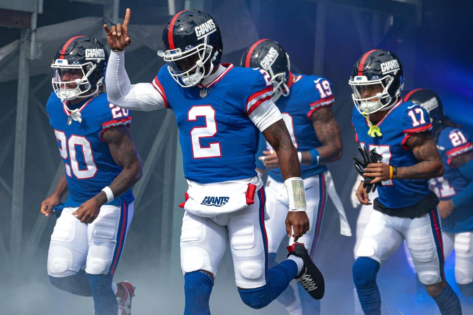 Oct 22, 2023; East Rutherford, New Jersey, USA; New York Giants quarterback Tyrod Taylor (2) runs out to the field with teammates before the game against the Washington Commanders at MetLife Stadium. Mandatory Credit: Vincent Carchietta-USA TODAY Sports