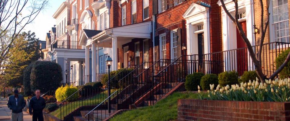 Richmond, VA, USA April 4, 2006 Two adult men walk past the historic homes on Monument Avenue in Richmond, Virginia