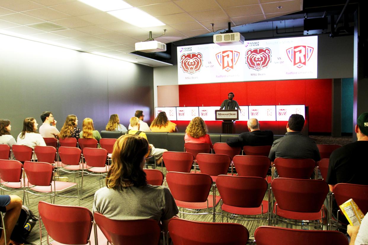 Audience members listen as MSU esports club president Roman Thomas speaks.