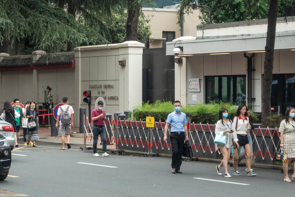 People walking past the entrance of the US consulate in Chengdu, southwest China's Sichuan province. (AFP via Getty Images)