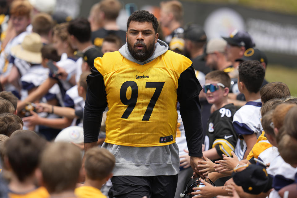 FILE - Pittsburgh Steelers defensive tackle Cameron Heyward runs through a gantlet of young fans as he arrives for the NFL football team's training camp workout in Latrobe, Pa., Thursday, July 27, 2023. The defense could be among the best in the league provided star linebacker T.J. Watt and defensive end Cam Heyward can remain healthy. Pittsburgh opens the season at home on Sept. 10 against San Francisco. (AP Photo/Gene J. Puskar, File)