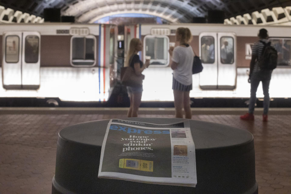 A final copy of the free commuter paper, Express, is seen at a Metro Center Station in downtown Washington, Thursday, Sept. 12, 2019. The Washington Post announced yesterday that it has decided to cease publication of its Express commuter paper, that has been handed out for free at Metro stations for 16 years. (AP Photo/Pablo Martinez Monsivais)