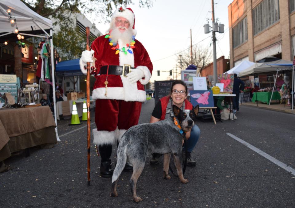 Sarah Elizabeth Bernard and her dog Blue pose with Santa Clause at a previous Alexandria WinterFete. Special treats, clothes, toys and even donating to a rescue in your pet's name are some of the gift options available for your pet.