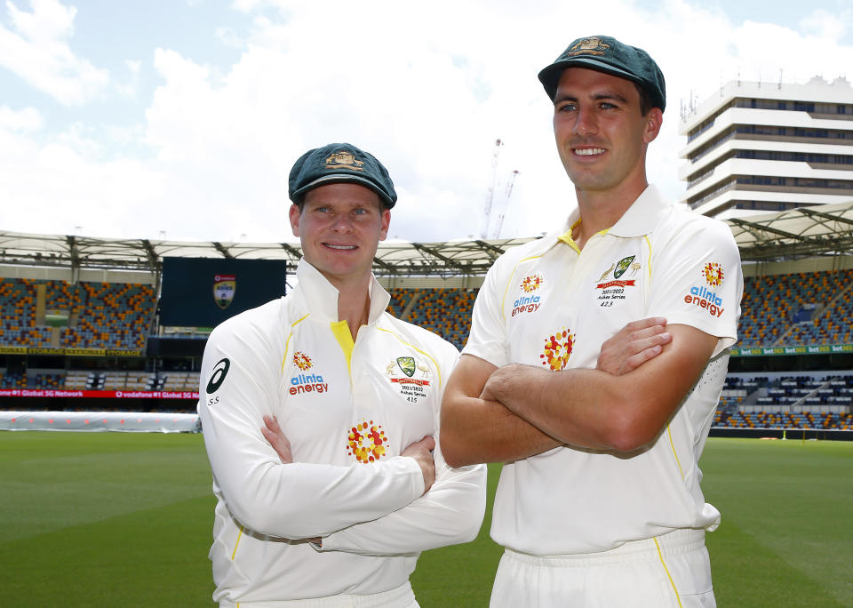 Steve Smith, left, and the Australian captain Pat Cummins pose for a photo at the Gabba cricket ground ahead of the first Ashes cricket test in Brisbane, Australia, Sunday, Dec. 5, 2021. (AP Photo/Tertius Pickard)
