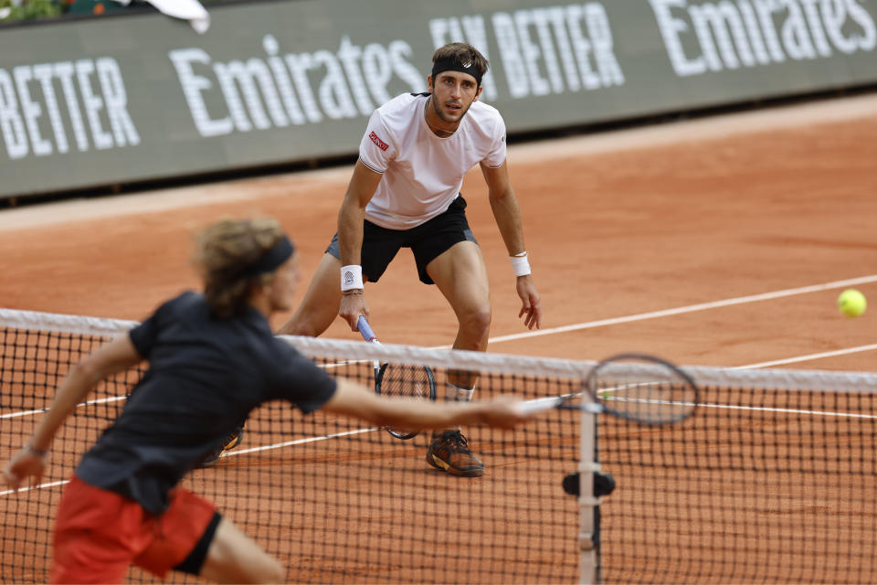 Germany's Alexander Zverev plays a shot against Argentina's Tomas Martin Etcheverry, rear, during their quarterfinal match of the French Open tennis tournament at the Roland Garros stadium in Paris, Wednesday, June 7, 2023. (AP Photo/Jean-Francois Badias)