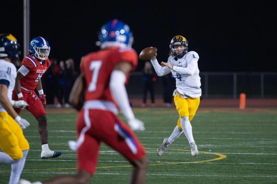 Oak Ridge Trojans quarterback Maddox Varella (4) passes downfield during the first quarter in the CIF Sac-Joaquin Division I section championship playoff game Friday, Nov. 25, 2022, at Hughes Stadium at Sacramento City College.