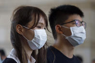 FILE - In this Wednesday, Aug. 5, 2020 file photo, activists Agnes Chow, left, and Joshua Wong arrive at a court in Hong Kong. Police arrested prominent pro-democracy activist Agnes Chow Ting at her home, on charges of inciting secession under the national security law, according to tweets by fellow activist Nathan Law, who is currently in Britain. A post on Chow's official Facebook page said police had arrived at her home and that her lawyers were rushing to the scene. (AP Photo/Kin Cheung, File)