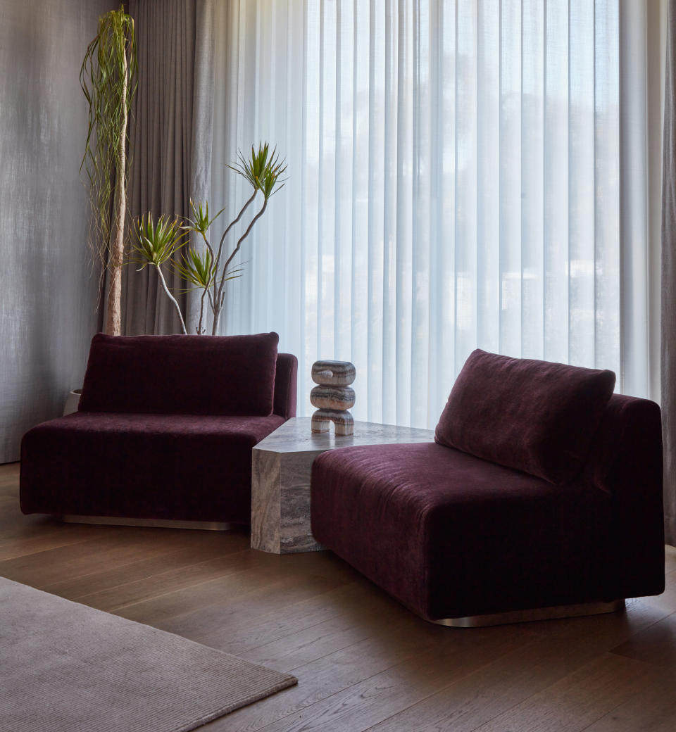 purple velvet accent chairs with marble coffee table in between