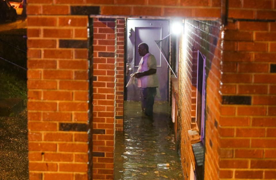 A man stands outside his flooded bottom floor apartment at Tatnall and 28th Street as torrential rains fell in the area early Wednesday evening, Nov. 11, 2020.