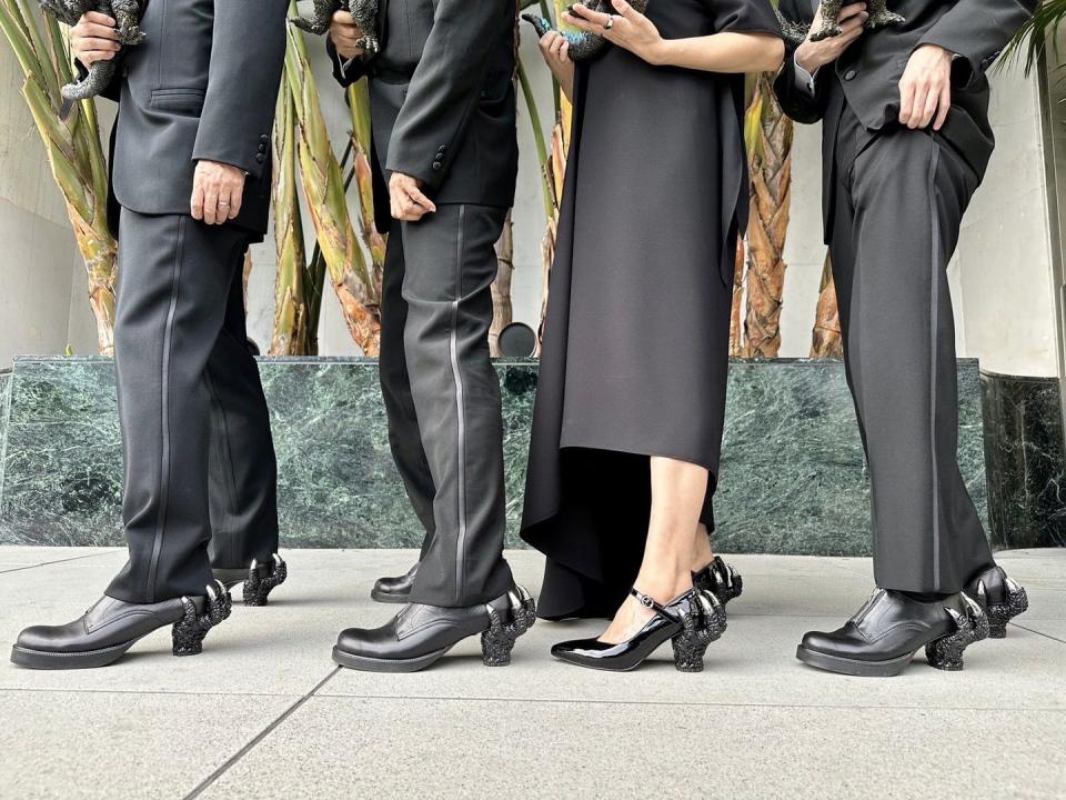 a group of people in black suits