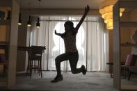 Michelle Rasul jumps around in the lobby of her apartment building in Dubai, United Arab Emirates, Sunday, May 9, 2021. Rasul, a 9-year-old girl from Azerbaijan who lives in Dubai, is scratching her way to the top as a DJ after competing in the DMC World DJ Championship. (AP Photo/Kamran Jebreili)