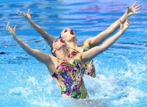 Canada's Claudia Holzner, left, and Jacqueline Simoneau, right, won gold in the women's duet free competition at the artistic swimming World Series Final on Sunday in Barcelona. (Antonio Bronic/Reuters/File - image credit)