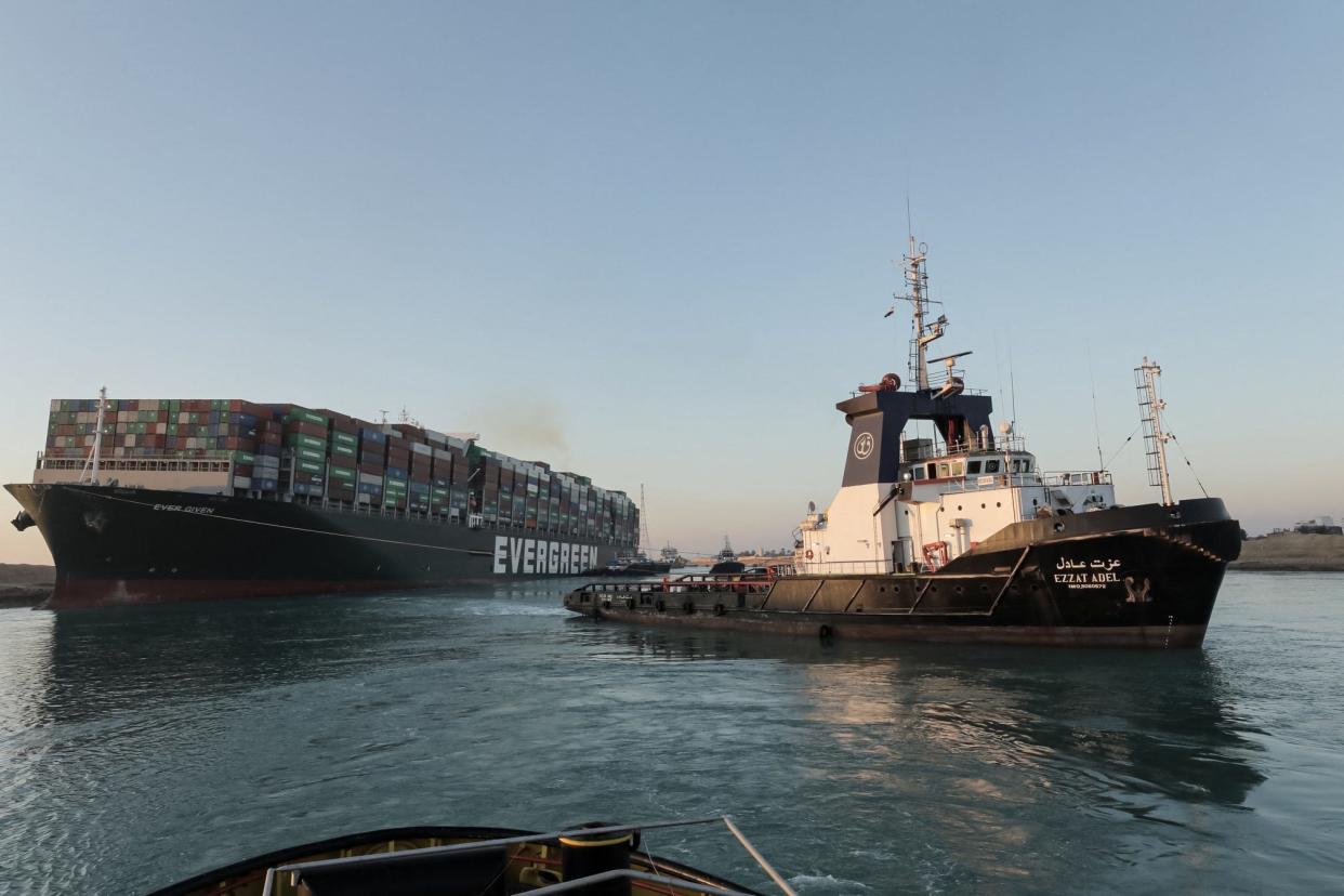 Tugboats pull the Panama-flagged MV Ever Given container ship, a 1,300-foot-long vessel, which was lodged sideways in Egypt's Suez Canal waterway.