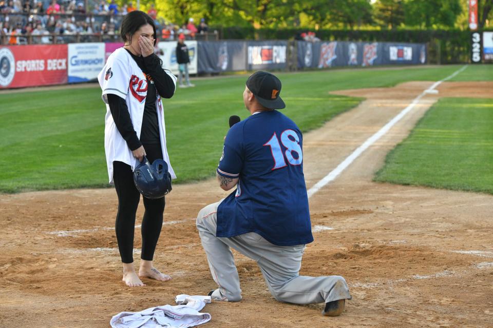 Ryan Wolfe proposes to Kasi Zack at home plate in the middle of the third inning during the Rox home opener Friday, June 3, 2022, at Joe Faber Field in St. Cloud.