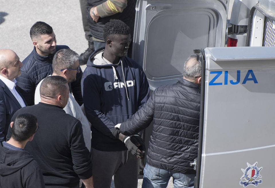 A migrant, suspected to be involved in the hijack of the Turkish oil tanker El Hiblu 1, is taken into custody in Valletta, Malta, Thursday March 28, 2019. A Maltese special operations team on Thursday boarded a tanker that had been hijacked by migrants rescued at sea, and returned control to the captain, before escorting it to a Maltese port. (AP Photo/Rene' Rossignaud)