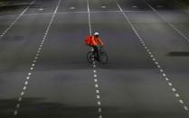 FILE PHOTO: A man who works for the mobile delivery app Rappi rides his bike on the street as Argentine President Alberto Fernandez announced an extension of the lockdown it has imposed as a measure to control the spread of the coronavirus disease (COVID-1