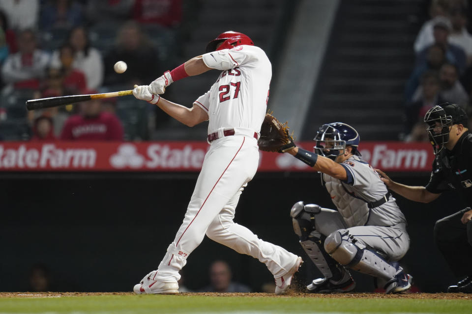 Los Angeles Angels' Mike Trout (27) lines out to center field during the fifth inning of a baseball game against the Houston Astros in Anaheim, Calif., Saturday, April 9, 2022. (AP Photo/Ashley Landis)