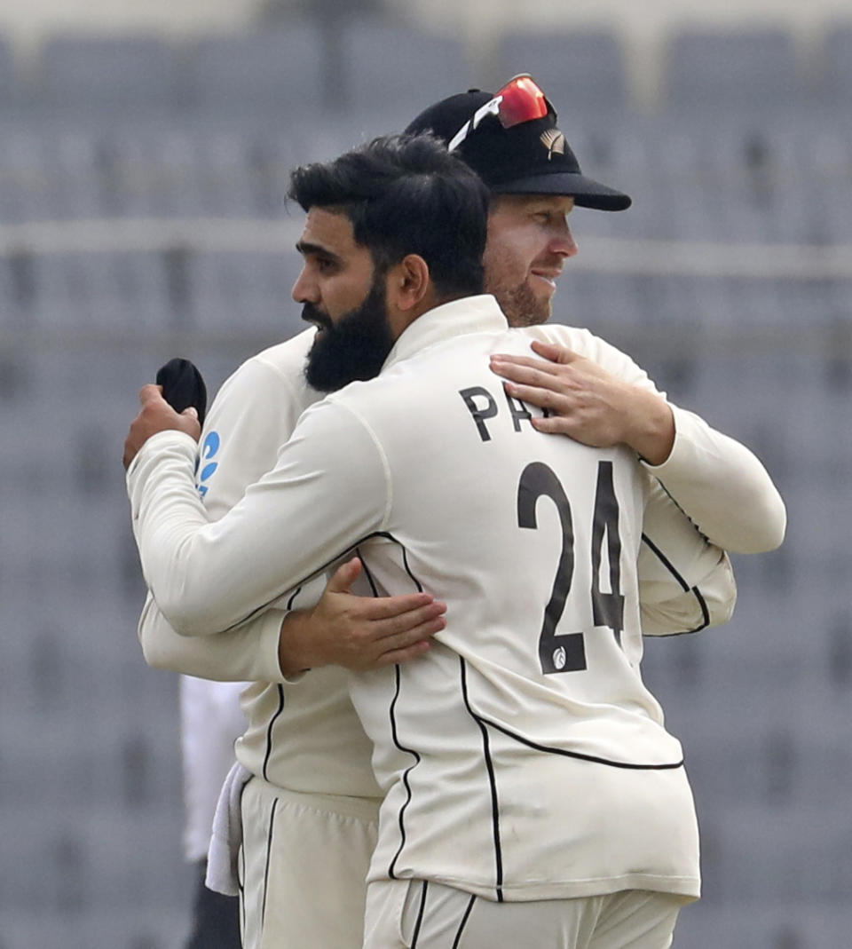 New Zealand Bowler Ajaz Patel is congratulated by a teammate for the wicket of Bangladesh's Shoriful Islam during the fourth day of the second test cricket match between Bangladesh and New Zealand in Dhaka, Bangladesh, Saturday, Dec. 9, 2023. (AP Photo/Mosaraf Hossain)