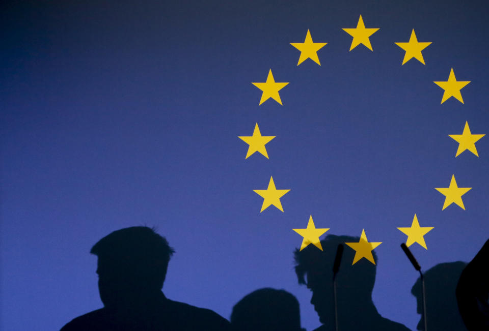 FILE - In this Jan. 31, 2020 file photo, shadows of the audience appear on a screen with the EU stars during a media conference at the Parlamentarium in Brussels. The bloc has been preoccupied for almost four years with Brexit, but now that Britain has left the bloc, the EU hopes to find more time to fix its own problems. (AP Photo/Virginia Mayo, File)