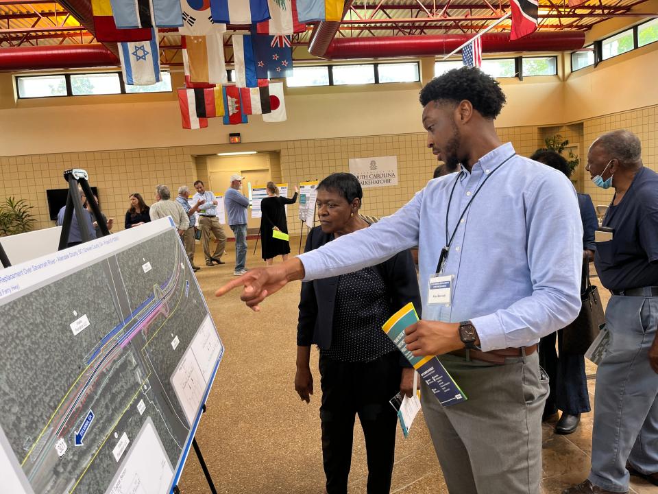 South Carolina Department of Transportation spokesman Alex Bennett, right, discusses with resident Eva Walker the finer details of the proposed project to replace the US 301 Bridge over the Savannah River that connects Sylvania, Ga., to Allendale, SC.