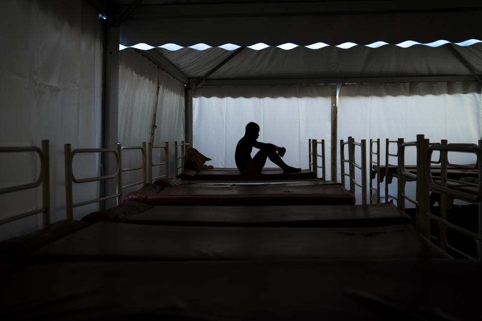 Mamadou Patherazi, from Guinea, sits on a bunk bed of the Modern Christian Mission Church in Fuerteventura, one of the Canary Islands, Spain, on Saturday, Aug. 22, 2020. The Modern Christian Mission is the main shelter for rescued migrants on the island of Fuerteventura. Some 4,000 migrants have reached the Canaries so far this year, the most in over a decade, raising alarm at the highest levels of the Spanish government. (AP Photo/Emilio Morenatti)