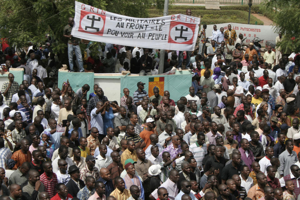 People gather in protest against the recent military coup, in Bamako, Mali Monday, March 26, 2012. About a thousand demonstrators protested Monday in Mali's capital to demand a return to constitutional order days after mutinous soldiers claimed power in a coup.(AP Photo/Harouna Traore)