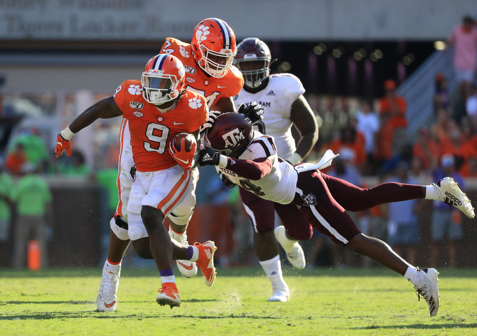 CLEMSON, SOUTH CAROLINA - SEPTEMBER 07: Keldrick Carper #14 of the Texas A&M Aggies tries to stop Travis Etienne #9 of the Clemson Tigers during their game at Memorial Stadium on September 07, 2019 in Clemson, South Carolina. (Photo by Streeter Lecka/Getty Images)