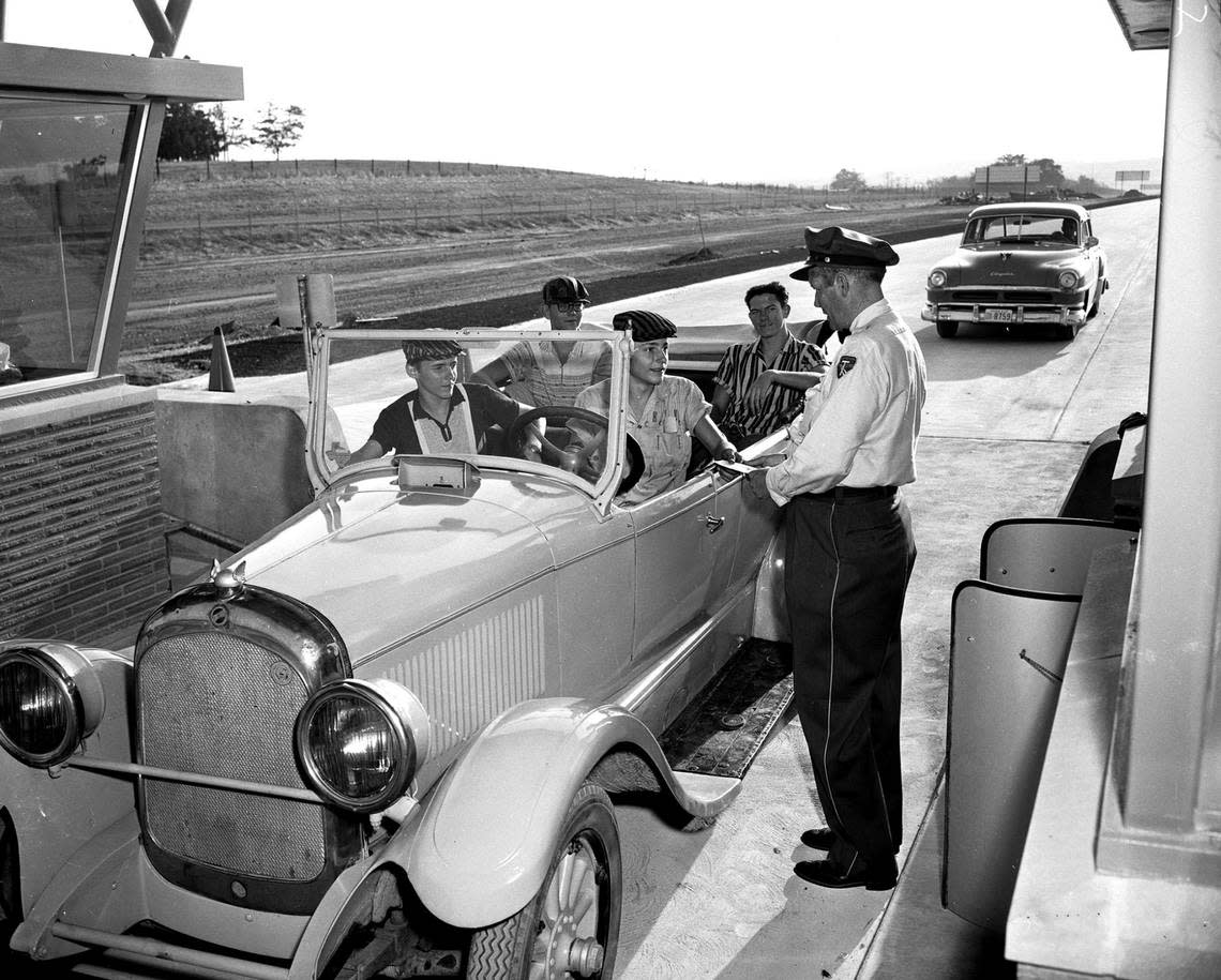 Aug. 27, 1957: James Tolar in a 1926 touring car with Robert Devine, James Garland and Dale Roberts pull up to the new Dallas-Fort Worth Turnpike toll plaza, along with attendant O.F. Riggles who stands next to the vehicle.