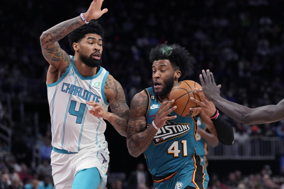Detroit Pistons forward Saddiq Bey (41) drives as Charlotte Hornets center Nick Richards (4) defends during the first half of an NBA basketball game, Friday, Feb. 3, 2023, in Detroit. (AP Photo/Carlos Osorio)