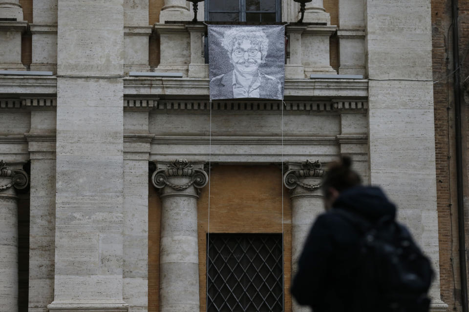 FILE - In this Monday, Jan. 25, 2021 file photo, a giant portrait of activist and researcher Patrick George Zaki, hangs from the facade of Rome's Capitol Hill. Italian lawmakers have given final approval to a motion calling on Italy’s government to grant citizenship to an Egyptian student, enrolled in an Italian university, who has been jailed in Cairo for nearly one year and a half. Egyptian courts have repeatedly extended the detention in jail of Patrick Zaki, a human rights activists since he was jailed in February 2020 after arriving in his homeland to visit family. (Cecilia Fabiano/LaPresse via AP)