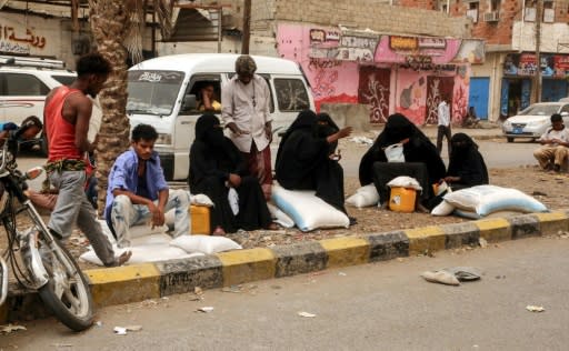 Yemeni women receive food aid in the coastal city of Hodeidah