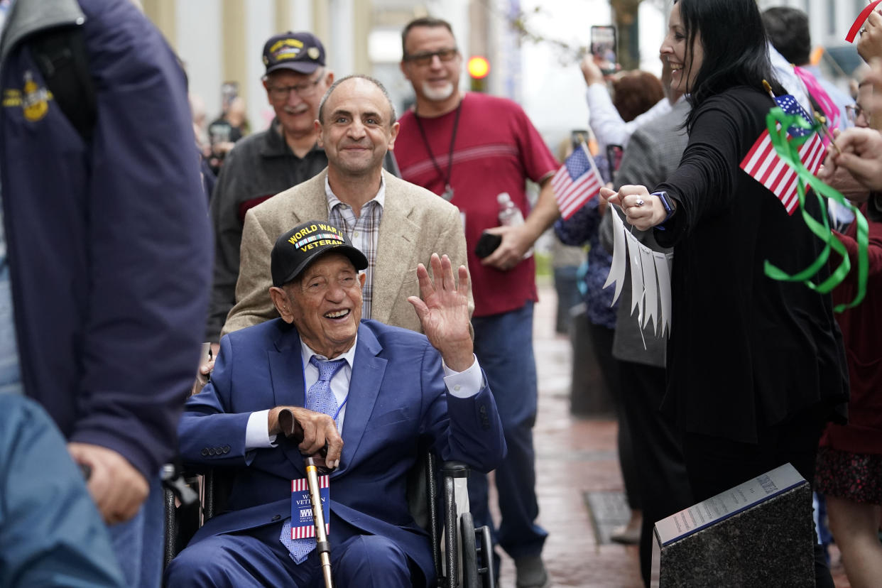 World War II veteran Joseph Eskenazi, who at 104 years and 11 months old is the oldest living veteran to survive the attack on Pearl Harbor, is greeted by staff as he arrives at the National World War II Museum to celebrate his upcoming 105th birthday in New Orleans, Wednesday, Jan. 11, 2023. (AP Photo/Gerald Herbert)