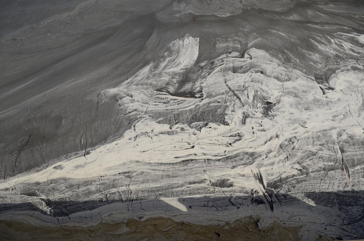 Swirls of coal ash in eddies and waters appear gray in the Dan River in Danville, Virginia,&nbsp;downstream from the Dan River Steam Station in Eden, North Carolina.&nbsp; (Photo: Charlotte Observer via Getty Images)