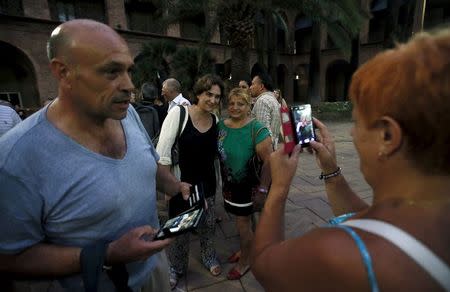Barcelona's mayor Ada Colau poses as she is pictured by people after an open plenary municipal council constitution of Nou Barris district in Barcelona, Spain, July 29, 2015. REUTERS/Albert Gea
