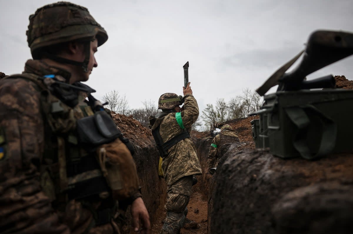 A Ukrainian infantryman of the 57th Separate Motorised Infantry Brigade, ‘Otaman Kost Khordienko’, uses a periscope in a trench near Bakhmut (AFP via Getty)