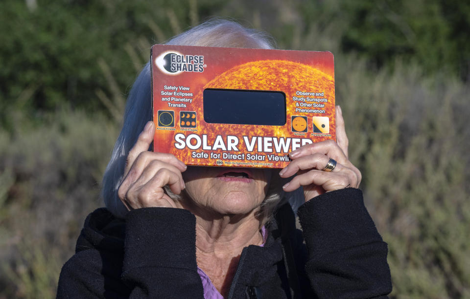 San Juan Capistrano, CA - October 14: Looking through a solar viewer, Linda Akins of Laguna Woods watches the annular solar eclipse at Caspers Wilderness Park in San Juan Capistrano early Saturday morning, October 14, 2023. At the height of the eclipse the moon covered approximately 70 percent of the suns surface. (Photo by Mark Rightmire/Digital First Media/Orange County Register via Getty Images)