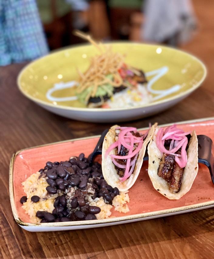 Glazed pork belly tacos with pickled red onions are served at Cactus Grille in Palm Beach Gardens.