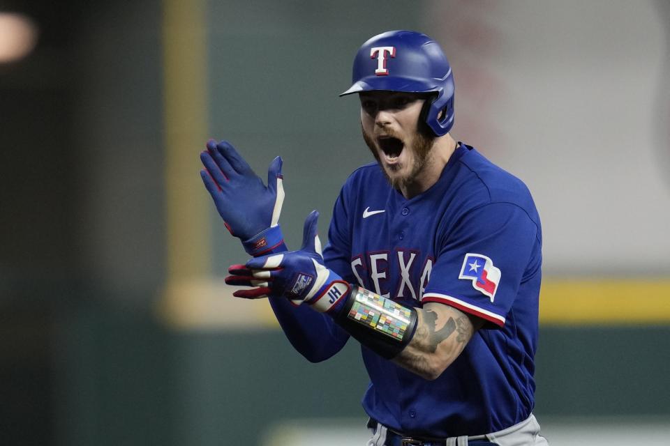Texas Rangers' Jonah Heim reacts after hitting a two-run home run during the fourth inning of Game 6 of the baseball AL Championship Series against the Houston Astros Sunday, Oct. 22, 2023, in Houston. (AP Photo/Godofredo A. Vásquez)