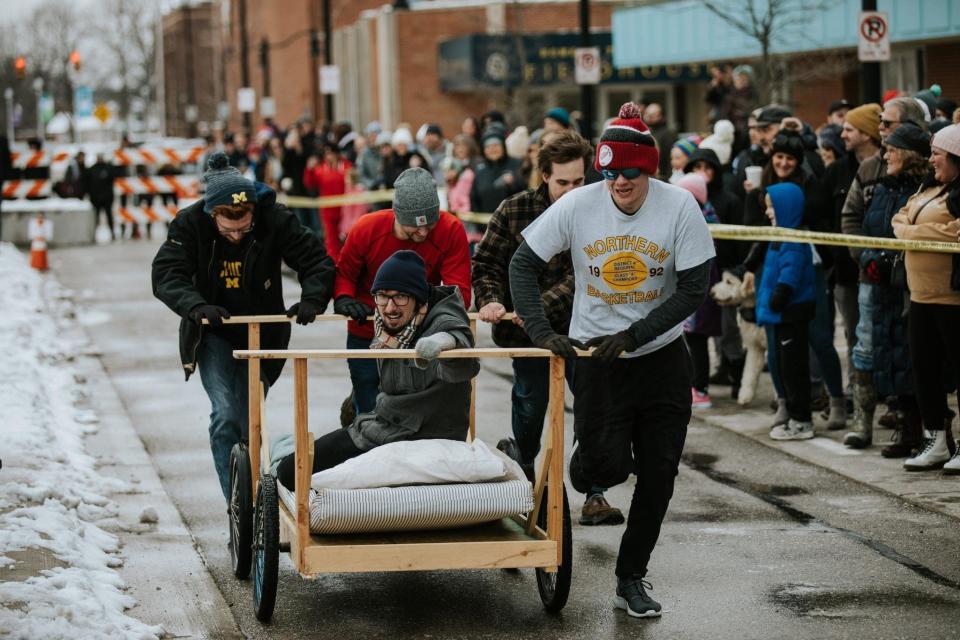 One of the bed race teams running toward the finish line at Chilly Fest 2023.