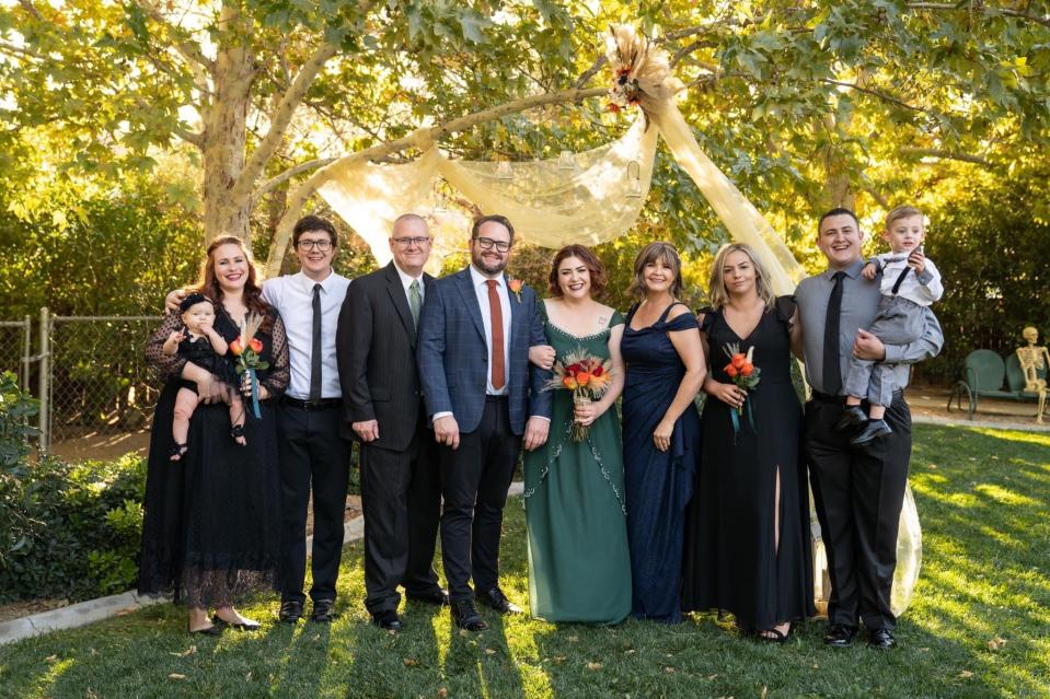 Local author Beckie Lindsey, fourth from right, poses with her family at the wedding of her daughter, Charity, and son-in-law, Matthew Cabe, in October 2021.