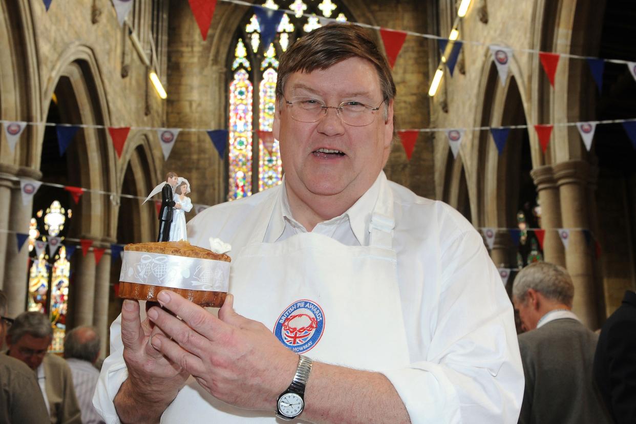 Food critic Charles Campion with a wedding cake pork and chicken pie at the British Pie Awards, St Marys Church, Melton Mowbray.   (Photo by Joe Giddens/PA Images via Getty Images)