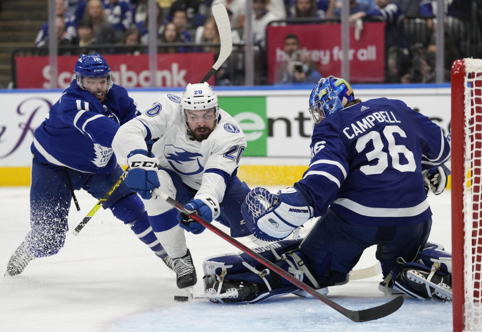 Tampa Bay Lightning left wing Nicholas Paul (20) falls toward Toronto Maple Leafs goaltender Jack Campbell (36) as Maple Leafs center Colin Blackwell (11) defends during the third period of Game 7 in an NHL hockey first-round playoff series in Toronto, Saturday, May 14, 2022. (Frank Gunn/The Canadian Press via AP)