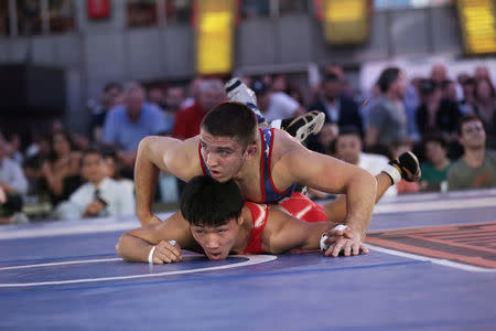 U.S. wrestler Zain Retherford pins Japanese wrestler Daichi Takatani at the "Beat The Streets" wrestling event in Times Square, New York City, U.S., May 17, 2017. REUTERS/Joe Penney