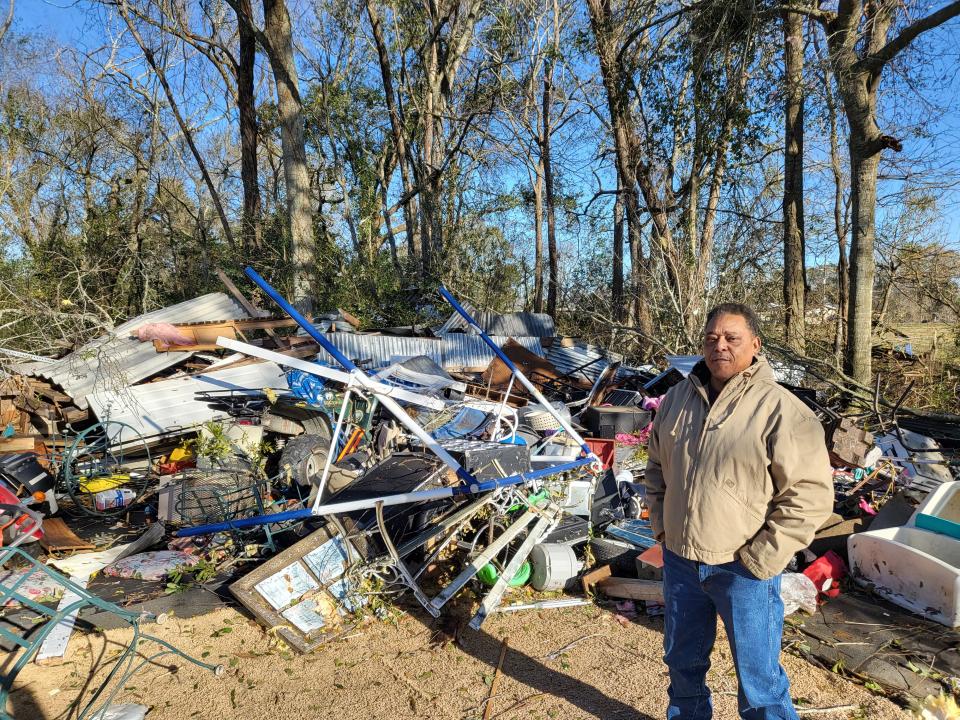 Ronald Johnson stands by what remains of his shed after it was hit by a tornado in Labadieville, Jan. 8.