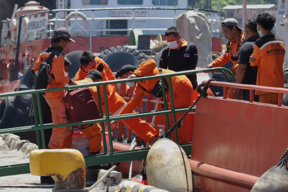 Crew members seen preparing for the search operation to find the submarine.