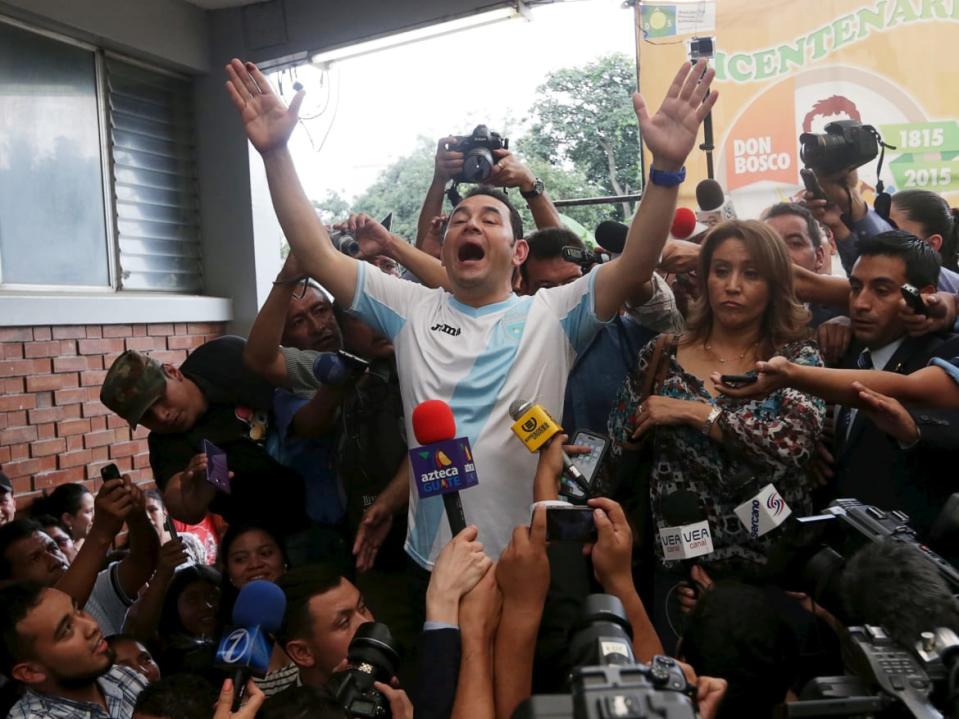 <div class="inline-image__caption"><p>"Jimmy Morales (C), presidential candidate for the National Convergence Front party (FCN), gestures while addressing the media next to his wife Gilda Marroquin (R) after casting his vote at a polling station in Guatemala City, October 25, 2015. A former TV comedian with no experience in government is poised to win Guatemala's presidential election on Sunday after a corruption scandal toppled the country's last leader and fueled voter outrage with the political establishment. Playing up his outsider status and promising clean government, 46-year-old Jimmy Morales has surged in opinion polls since a probe into a multi-million dollar customs racket led to the resignation and arrest of President Otto Perez. Voter surveys show Morales is set to easily win Sunday's run-off vote against former first lady Sandra Torres, who also vows to tackle corruption but is seen by many voters as part of the old political order. REUTERS/Jorge Dan Lopez TPX IMAGES OF THE DAY"</p></div> <div class="inline-image__credit">REUTERS</div>