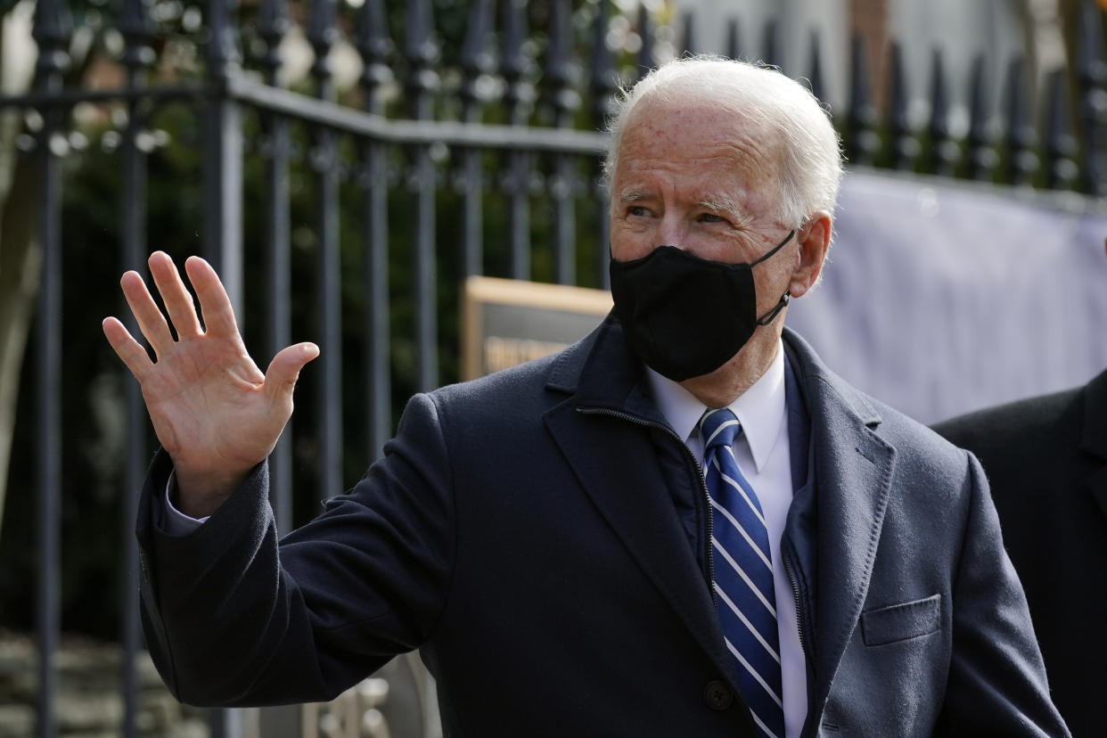 President Joe Biden waves as he departs after attending Mass at Holy Trinity Catholic Church, Sunday, Jan. 24, 2021, in the Georgetown neighborhood of Washington. (AP Photo/Patrick Semansky)